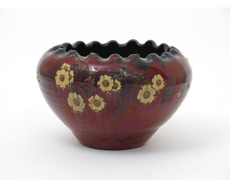 An Early Sunflower Pottery jardiniere by Sir Edmund Elton, ovoid form with inverted pinched rim, slip decorated and applied w