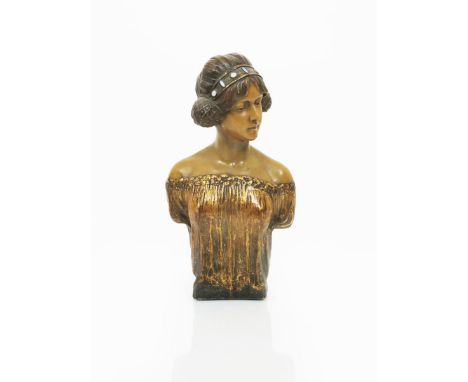 An Art Nouveau Goldscheider Pottery bust cast from a model by Montenave, model no.2842,  modelled with sideways, downcast loo