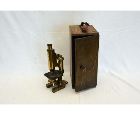 A brass cased students microscope, stamped BPMS, in an oak travelling case.  Est £10-20