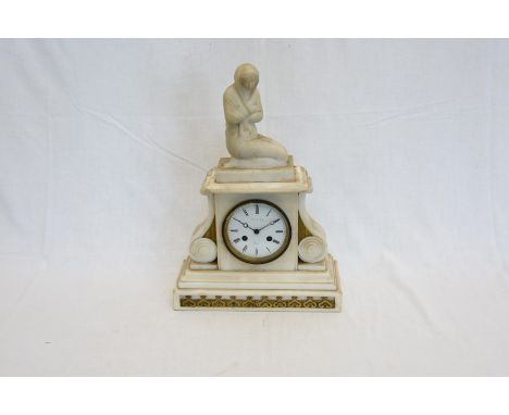 A French white marble mantel clock depicting a figure wrapped in a shawl to the pediment, the enamelled dial with roman numer