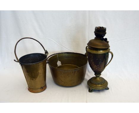 A copper and brass twin handled oil lamp, a brass tapering bucket with wrought iron handle, a brass bowl, a brass preserving 