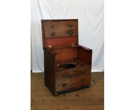 A Victorian mahogany commode in the form of a chest of four long drawers with hinged top section, on bracket feet.  26ins wid