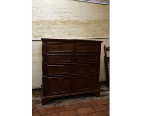 An 18th century oak chest of two short and three long drawers with split panelled sides, on bracket feet.  37¾ins wide.  Est 