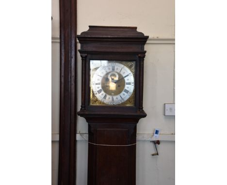 A 19th century oak cased longcase clock, the hood with turned pilasters, the dial with pierced brass mask decorated spandrels