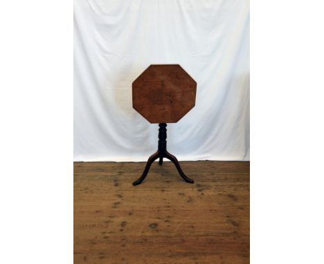 An octagonal topped occasional table, on turned stem, tripod legs and pad feet.  18¼ins wide.  Est £10-20