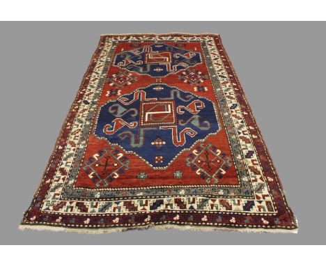 A CHONDZORESK RUG, KARABARAGH, SOUTH CAUCASUS, CIRCA 1900. the rich terracotta field with two typical indigo ‘Swastika’ medal