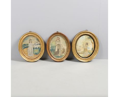 THREE 19TH CENTURY SILKWORK PICTURES. all depicting female subjects with sheep or birds in landscapes, in glazed oval frames,