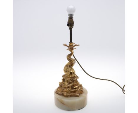 AN EARLY 20TH CENTURY GILT TABLE LAMP. in the form of a stylised dolphin on a solid circular base, fitted for electricity, he
