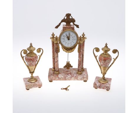 A FRENCH CLOCK GARNITURE. the 3 1/2" porcelain dial in an engine turned gilt drum case on gilt and marble column supports wit