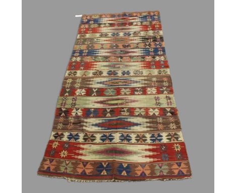 AN ANATOLIAN KILIM, CIRCA 1880. the field comprised of polychrome bands of serrated medallions and geometric devices, 375cm x