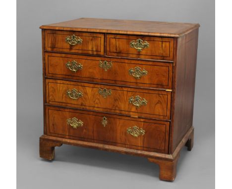 AN 18TH CENTURY CHEST OF DRAWERS. the quarter-veneered top above two short and three long inlaid drawers, on ogee bracket fee
