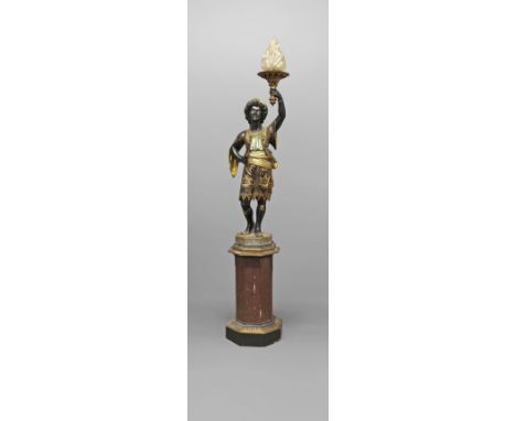 AN ITALIAN POLYCHROME BLACKAMOOR TORCHÈRE. the figural column in gilt floral robes holding aloft a flaming torch with glass s