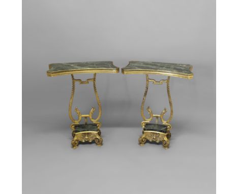 A PAIR OF CONTINENTAL GILT AND GREEN MARBLE CONSOLE TABLES. the shaped tops with pierced mounts on scrolling stylised fish st