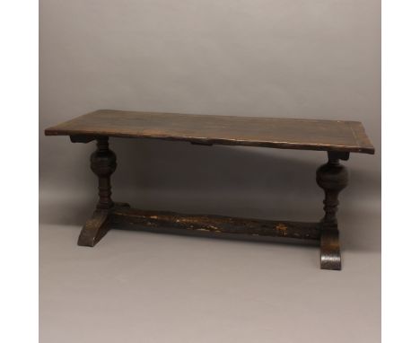 AN 18TH CENTURY OAK REFECTORY TABLE. of four plank construction with cleated ends, on bulbous supports, height 74cm, width 18
