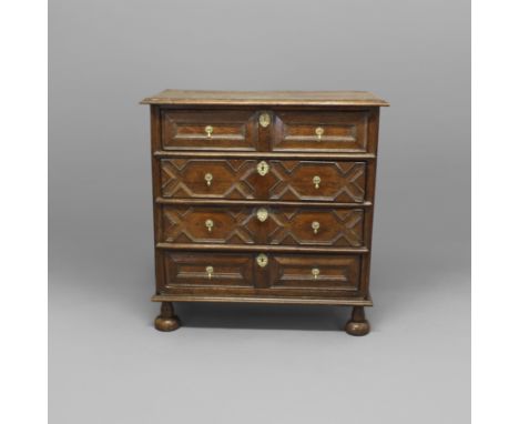 A 17TH CENTURY OAK CHEST OF DRAWERS. the moulded three plank top above four long drawers with geometric panelling, raised on 