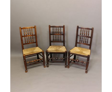 A SET OF SIX ASH SPINDLE BACK RUSH SEATED DINING CHAIRS. late 18th or early 19th century, with two rows of spindles and turne