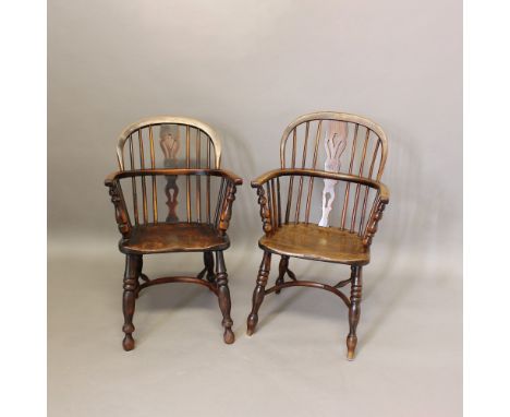 A NEAR PAIR OF ASH AND ELM WINDSOR ARMCHAIRS. 19th century, on turned supports and crinoline stretchers, height 93cm (2). * E