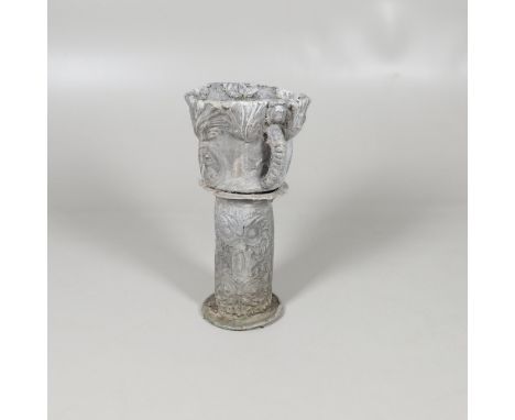 A LEAD GARDEN PEDESTAL PLANTER. decorated with stylised leaves above twin figural circular panels and loop handles, on a scro