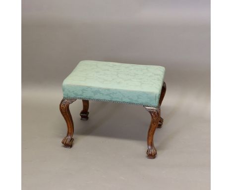 AN 18TH CENTURY WALNUT FOOT STOOL. with green upholstery on cabriole legs carved with oak leaf and acorn decoration, height 4