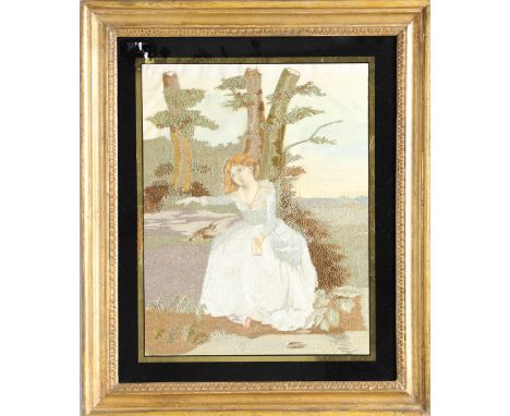 A 19TH CENTURY SILKWORK PICTURE. depicting a girl seated with a dog on a leash, in a gilt mount and rosewood frame, frame siz