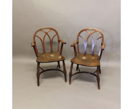 A PAIR OF 19TH CENTURY YEW AND ELM WINDSOR CHAIRS. in the Gothic style, with hoop backs, wavy arm supports and crinoline stre