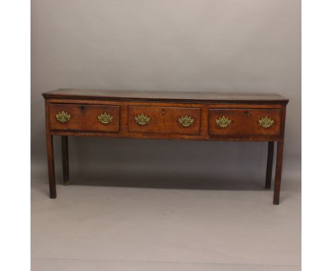 AN OAK DRESSER BASE. 18th century and later, the plank top above three drawers on square section legs, height 87cm, width 191