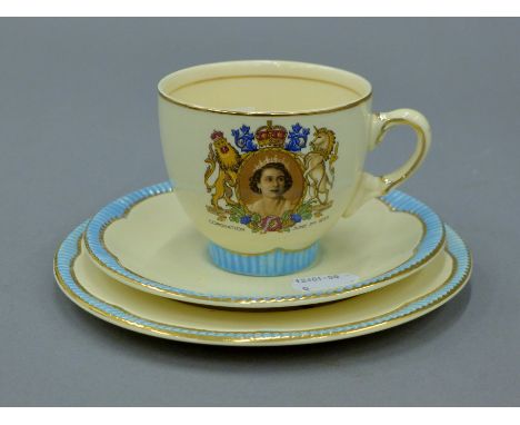 A Clarice Cliff Queen Elizabeth II Coronation trio. The plate 16.5 cm diameter.