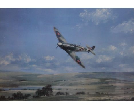 A print of a Spitfire in flight, framed and glazed. 68 x 48.5 cm.