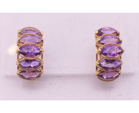 A pair of 14 k gold and amethyst earrings. 1.5 cm high. 4.3 grammes total weight. 