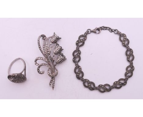 A silver marcasite brooch, bracelet and ring. The bracelet 18 cm long.