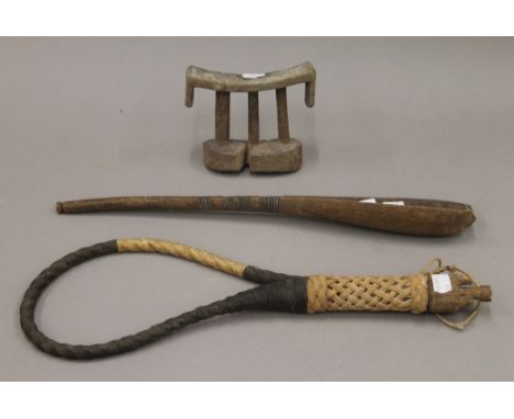 An African tribal wooden head rest, a scoop and a whip. The former 14 cm wide.