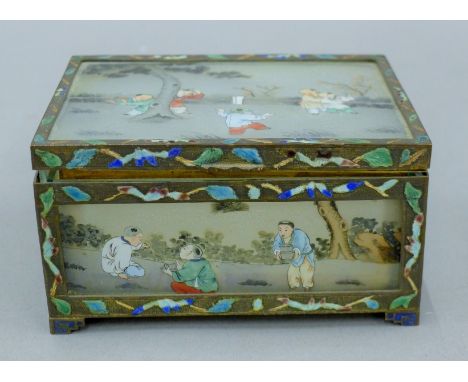 A Chinese enamel decorated glass panel set trinket box. 11 cm wide.