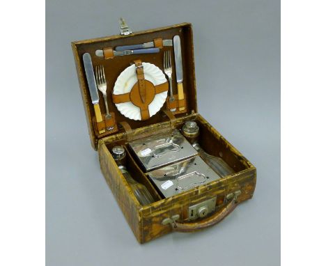 A vintage crocodile skin cased fitted picnic set. 28.5 cm wide. 