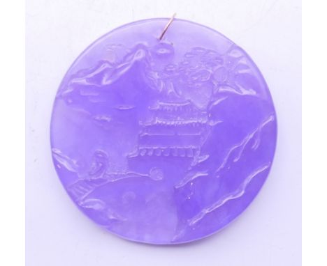 A gold mounted lavender jade pendant. 5.5 cm diameter. 