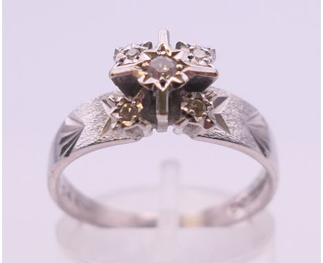 An 18 ct white gold diamond ring. Ring size P. 