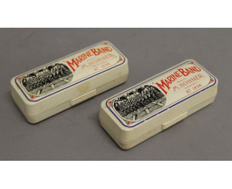 Two Hohner Marine Band harmonicas, boxed.  11 cm long.