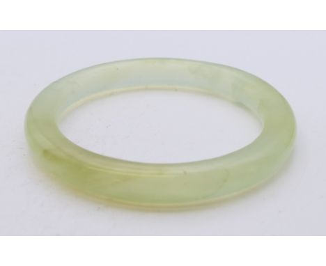 An icy jade bangle. Inner diameter approximately 6 cm.
