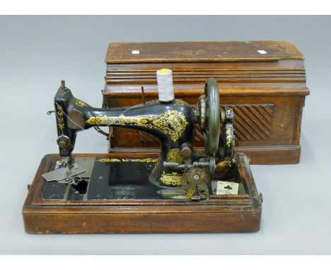A vintage cased Singer sewing machine. 47 cm long.