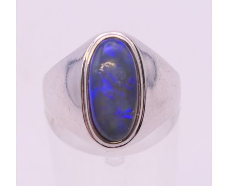 An 18 k white gold and opal ring. Ring size O/P.