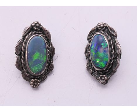 A pair of silver and opal clip-on earrings. 2 cm high.