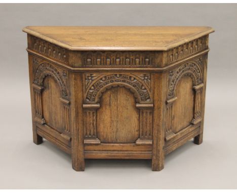 A carved oak canted corner trunk. 92 cm long, 61 cm high, 37 cm deep.