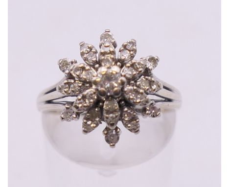 A 14 k white gold diamond cluster ring. Ring size M/N.
