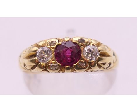 An 18 ct gold diamond and ruby ring. Ring size N/O. 5 grammes total weight.