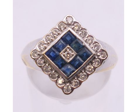 An Art Deco style 18 K white and yellow gold diamond and sapphire ring. Ring size P.