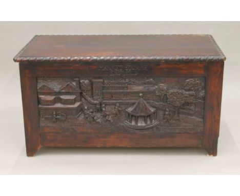 A trunk carved with scenes of Enfield. 88 cm long.