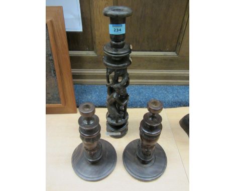 Large carved hardwood African figural candle stick and a pair smaller figural candle sticks