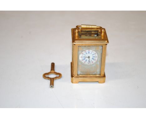 A miniature gilt Sevres style carriage clock