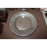 A copper Islamic decorated metal charger