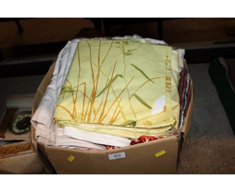 A box containing curtains and fabric