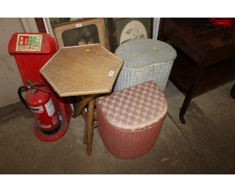 Two Lloyd loom linen baskets and a cane hexagonal topped side table 